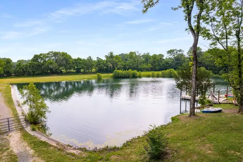 a view of a lake with houses in the back