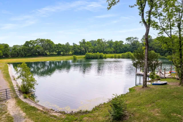 a view of a lake with houses in the back