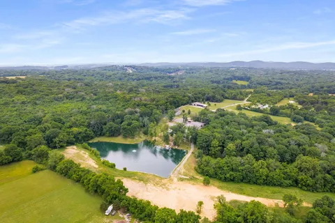 an aerial view of residential houses with outdoor space and swimming pool