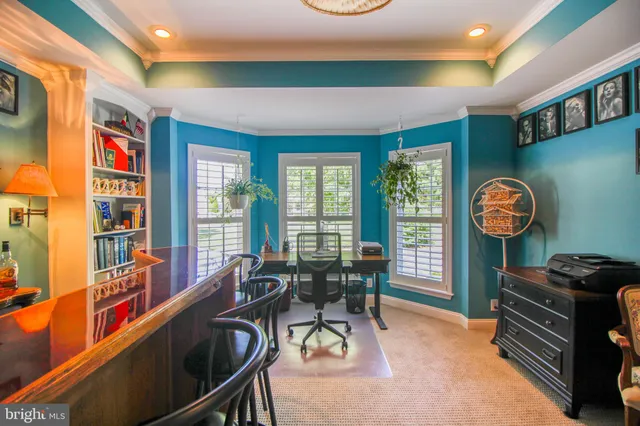 a dining room with furniture a large window and wooden floor