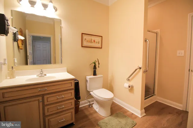 a kitchen with stainless steel appliances granite countertop a stove top oven a dining table and chairs with wooden floor