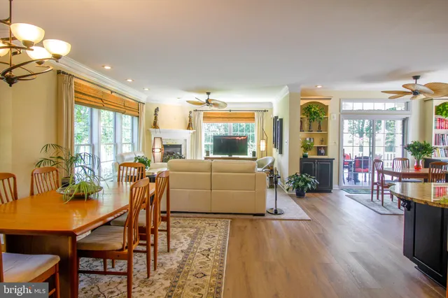 a kitchen with stainless steel appliances granite countertop a stove and kitchen island with a large window