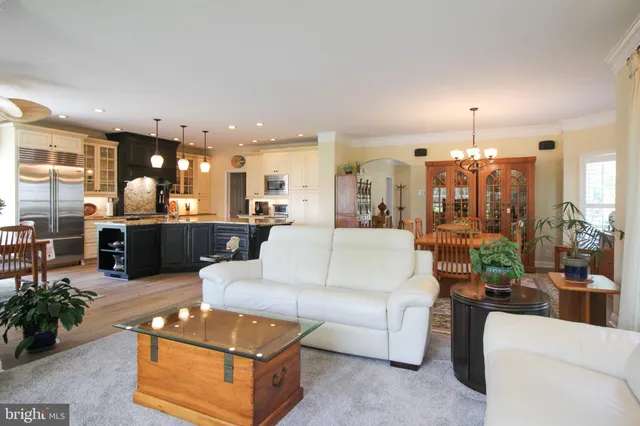 a bathroom with a tub a sink double vanity and a mirror