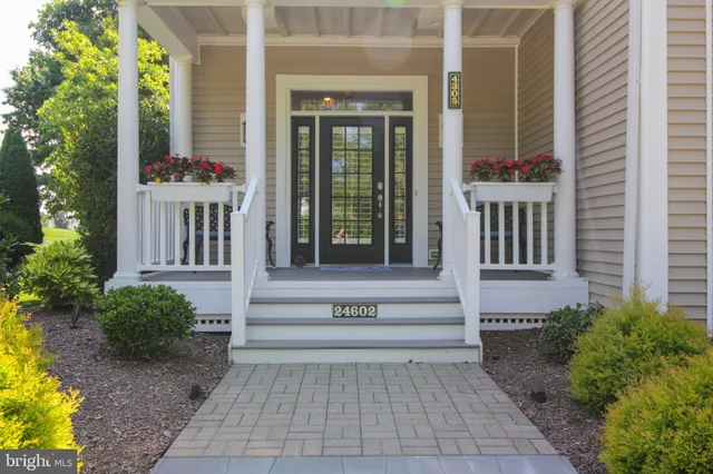 a view of a house with backyard sitting area and garden