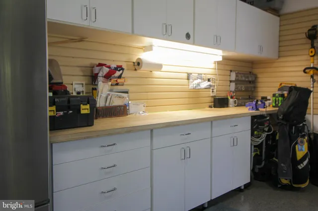 a spacious bedroom with a bed and large windows