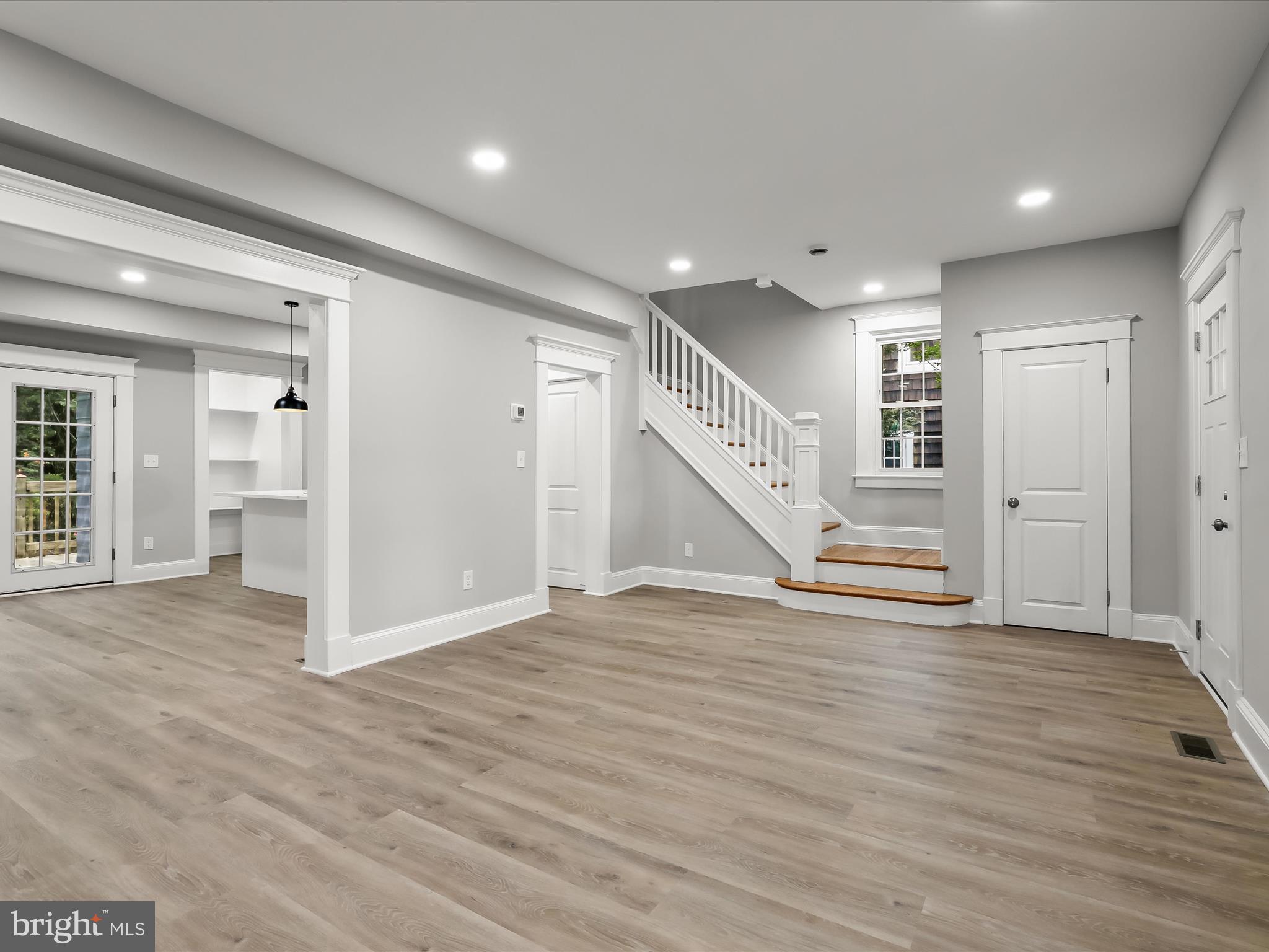 507 Westgate Road Baltimore, MD 21229 - Photo 10 of 47 a view of an empty room with wooden floor and stairs