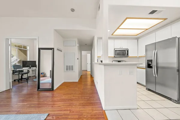 a kitchen with stainless steel appliances a refrigerator and a stove top oven