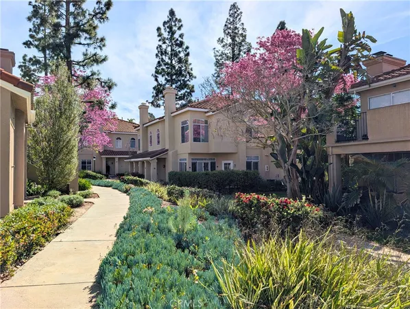 a front view of a house with a yard and fountain