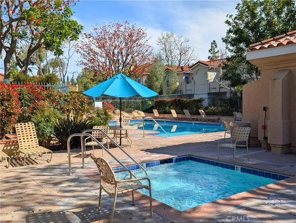 a patio with a table and chairs under an umbrella