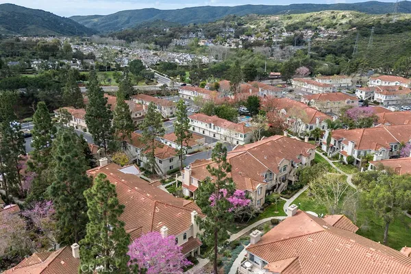 an aerial view of lake and residential houses with outdoor space