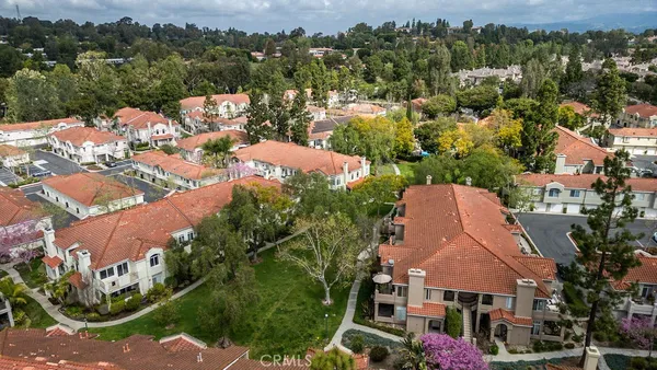 an aerial view of multiple houses with yard