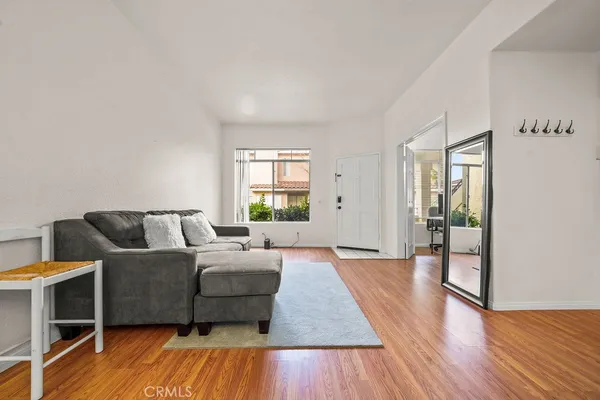 a living room with furniture and a wooden floor