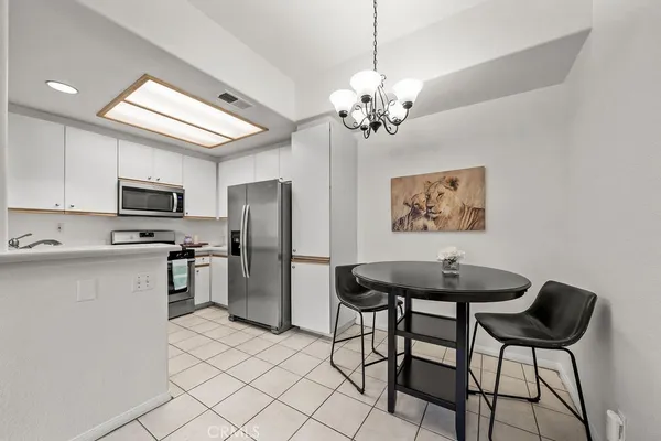 a view of a kitchen area with microwave and refrigerator