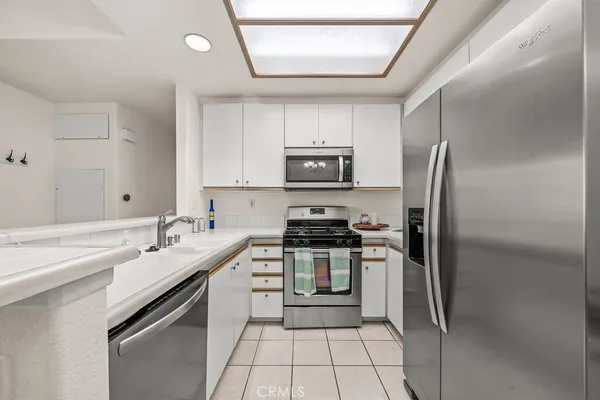 a kitchen with a sink stainless steel appliances and cabinets