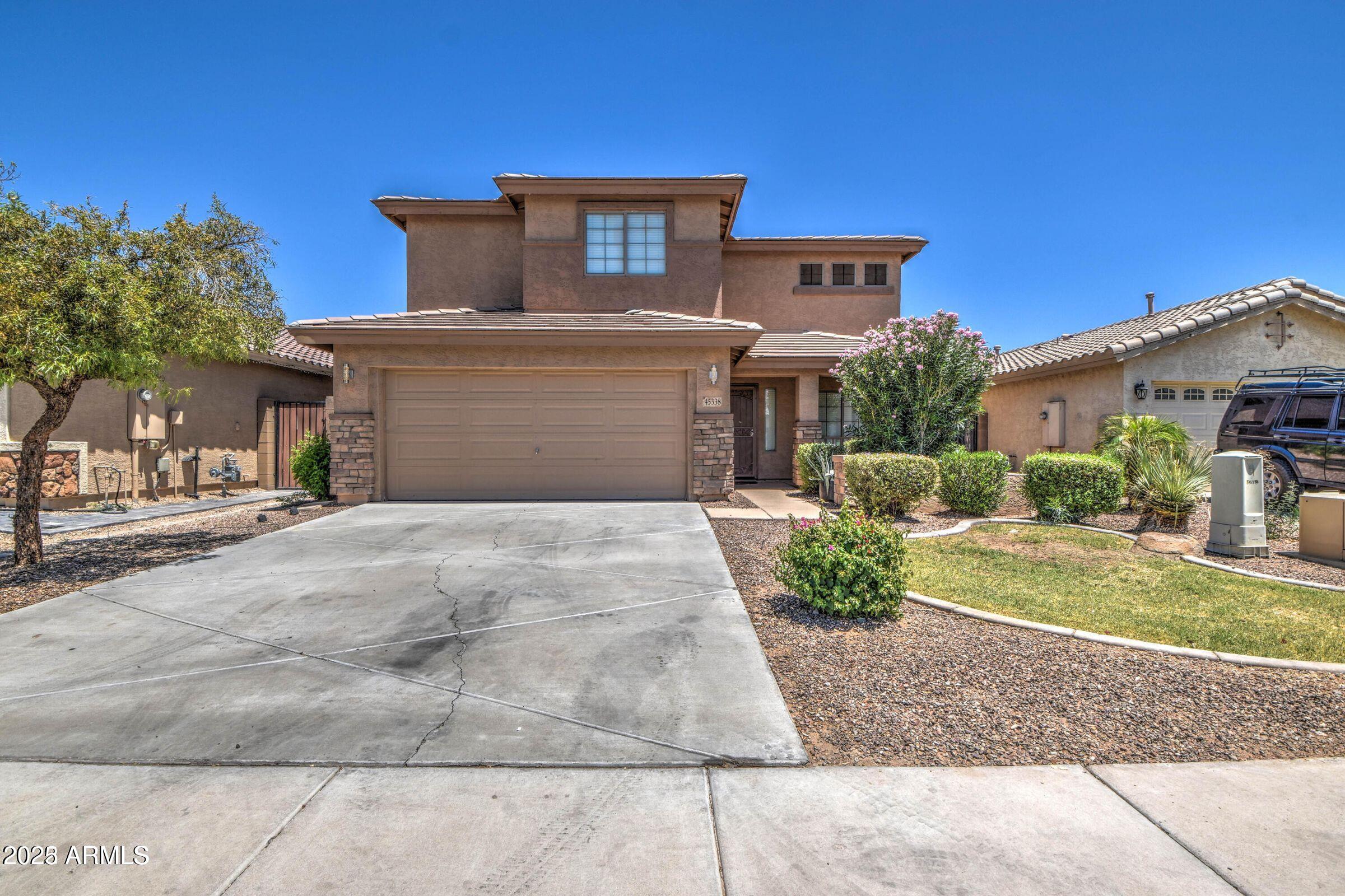45338 West Norris Road Maricopa, AZ 85139 - Photo 1 of 6 a front view of a house with a yard and garage