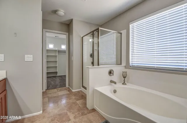 a bathroom with a bathtub and a shower