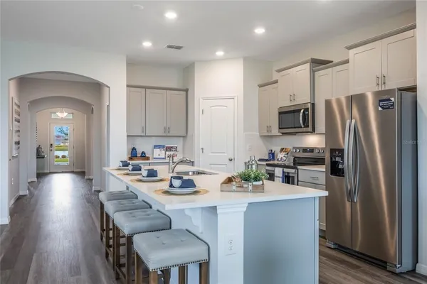 a kitchen with white cabinets and white appliances