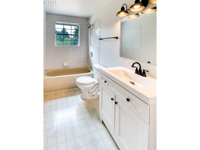 a bathroom with a sink a toilet and a bathtub