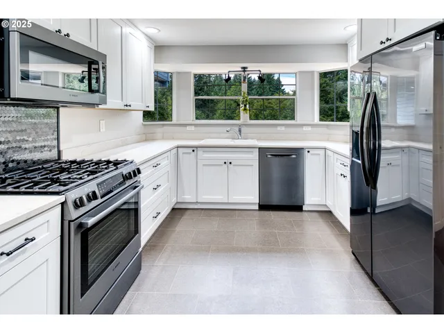 a kitchen with a stove a sink and a refrigerator