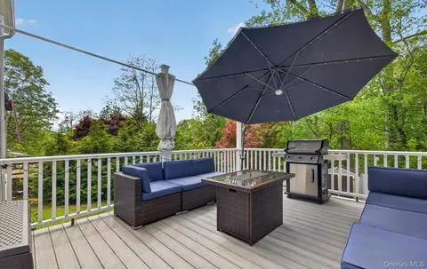 a view of a deck with furniture and wooden deck