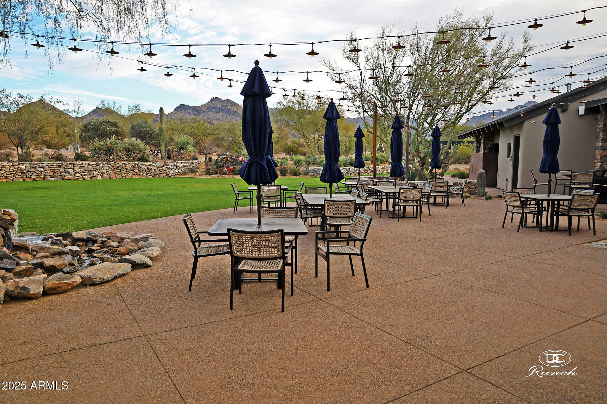 9190 East Hoverland Road Scottsdale, AZ 85255 - Photo 32 of 35 a view of a patio with dining table and chairs with plants and wooden fence