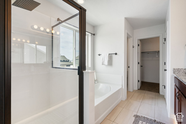 3456 South Linden Way Syracuse, UT 84075 - Photo 23 of 50 Primary en suite featuring a stall shower, vanity, a bath, a walk in closet, and tile patterned floors