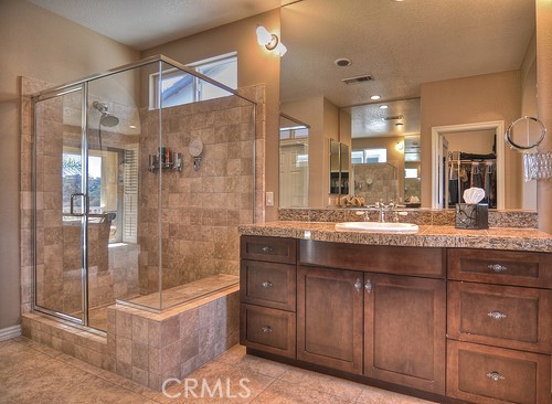 10 Prescott Aliso Viejo, CA 92656 - Photo 21 of 29 a bathroom with a granite countertop sink a mirror a bathtub and shower