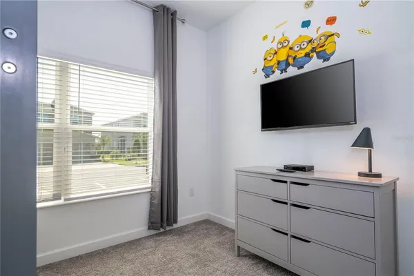 a kitchen with a sink a refrigerator and chairs
