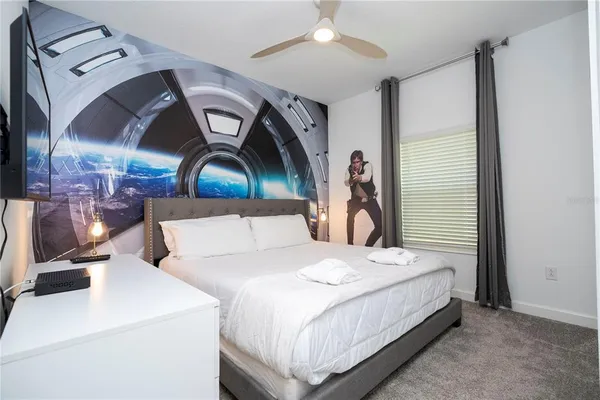 a living room with furniture a flat screen tv and a window