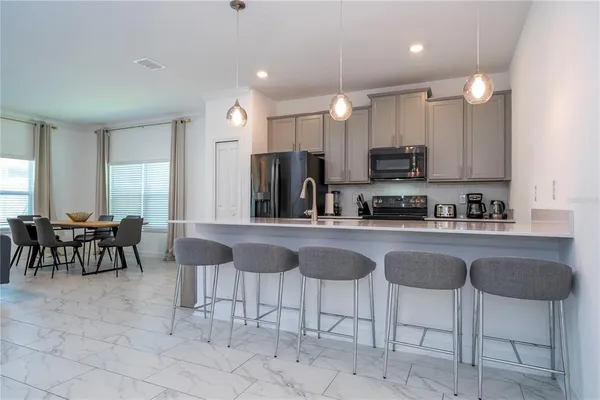 a bedroom with a flat screen tv on the dresser and a flat screen tv
