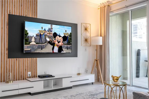 a bedroom with a bed and flat screen tv