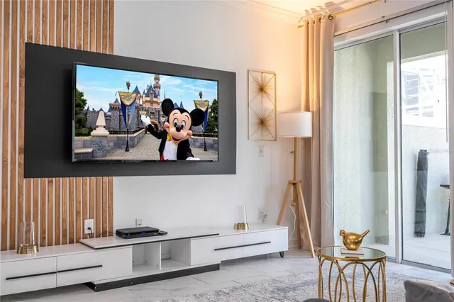 a bedroom with a bed and flat screen tv