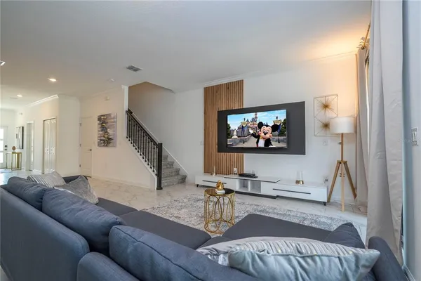 a view of a backyard with furniture and floor to ceiling window