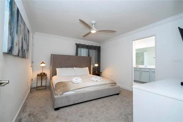 a view of living room kitchen with stainless steel appliances wooden floor and window