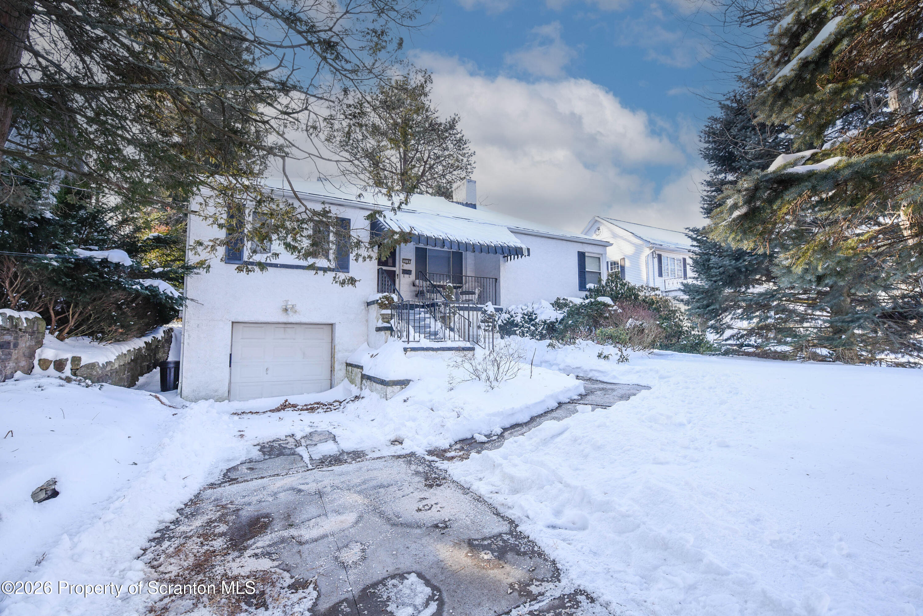 a view of a house with a snow in the yard