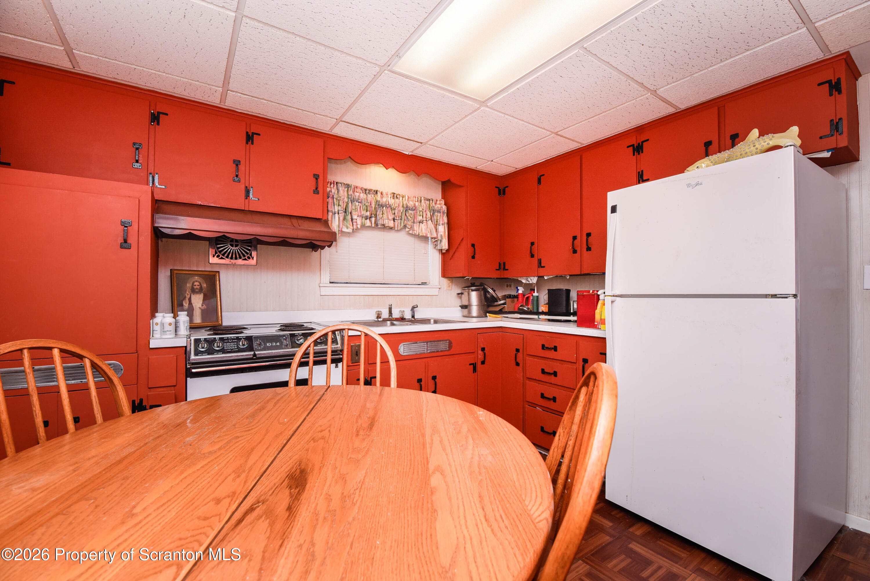 218 Lake Scranton Road Scranton, PA 18505 - Photo 14 of 45 a bed sitting in a kitchen with stainless steel appliances granite countertop furniture and a refrigerator