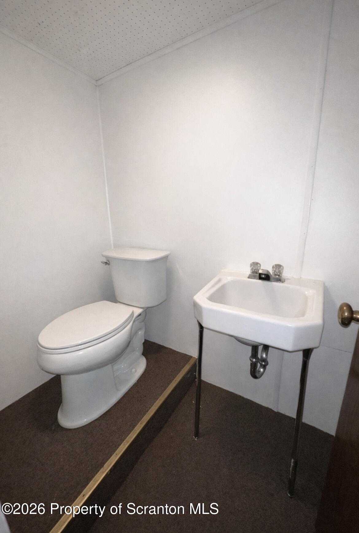 218 Lake Scranton Road Scranton, PA 18505 - Photo 15 of 19 a white toilet sitting next to a bathroom sink