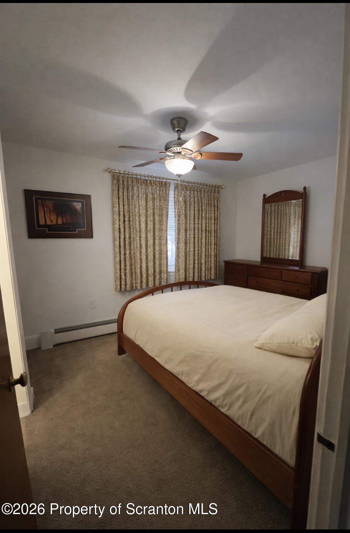 218 Lake Scranton Road Scranton, PA 18505 - Photo 6 of 19 a bedroom with a large bed and a chandelier