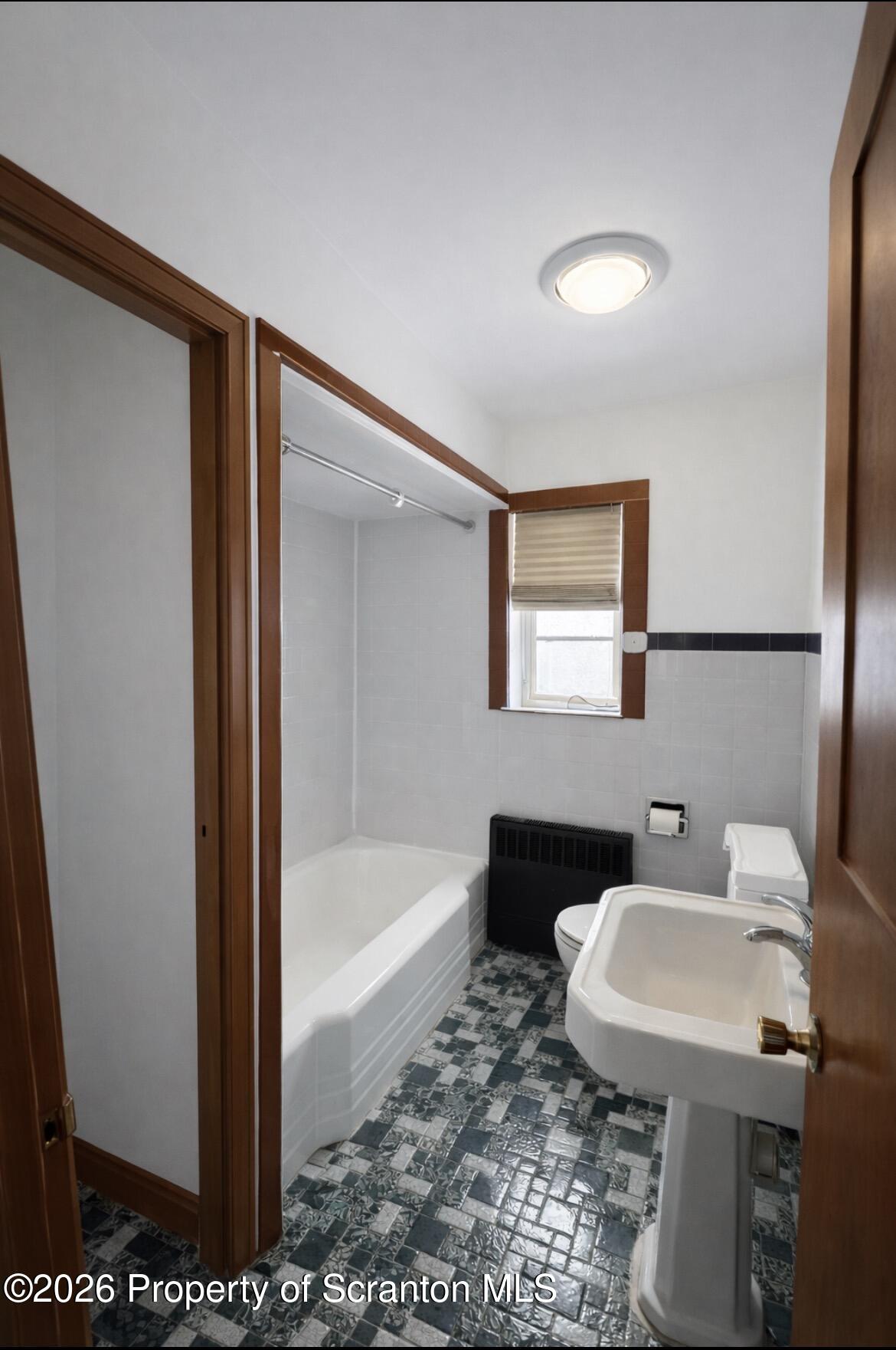 218 Lake Scranton Road Scranton, PA 18505 - Photo 7 of 19 a bathroom with a sink a toilet a mirror and bathtub