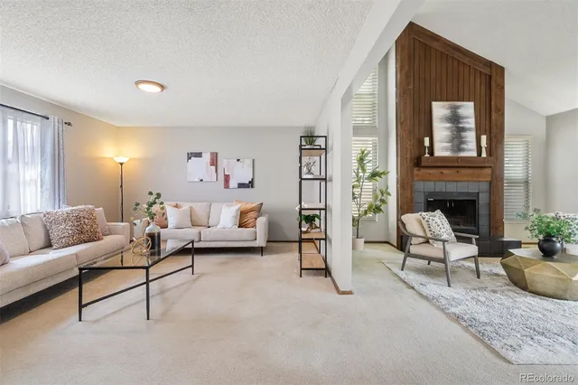 a kitchen with stainless steel appliances kitchen island granite countertop a refrigerator a stove a sink dishwasher and a dining table with wooden floor