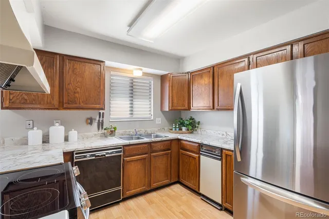 a spacious bedroom with a large bed and a chandelier