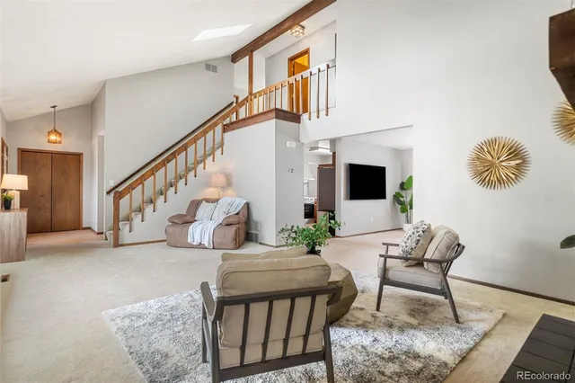 a spacious bedroom with a bed and a chandelier