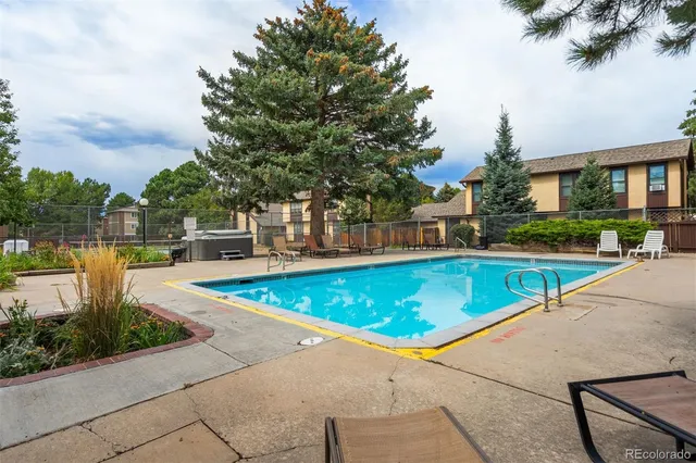 a living room with furniture large window and a fireplace