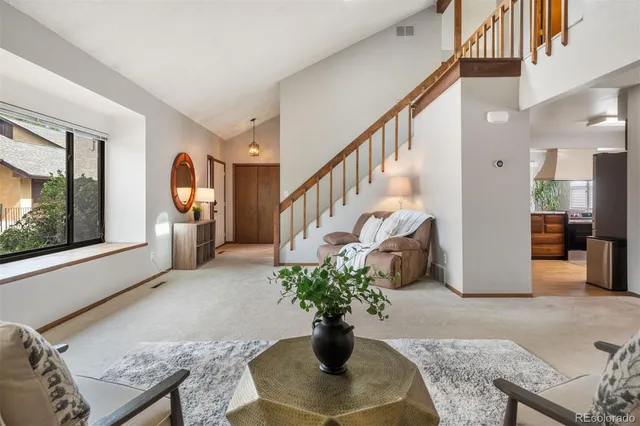 a living room with furniture large window and a fireplace