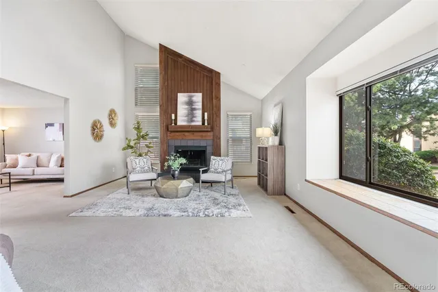 a living room with furniture potted plant and a window