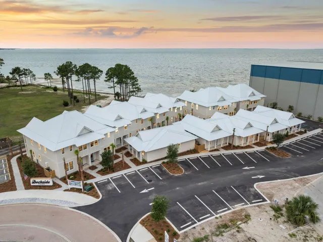a view of a terrace with lawn chairs