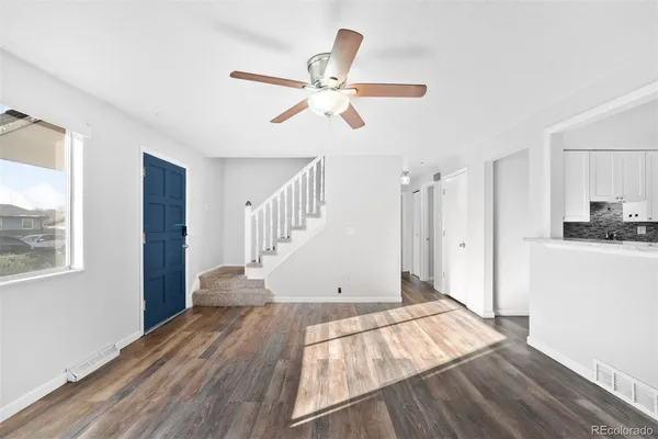 a view of empty room with wooden floor and window