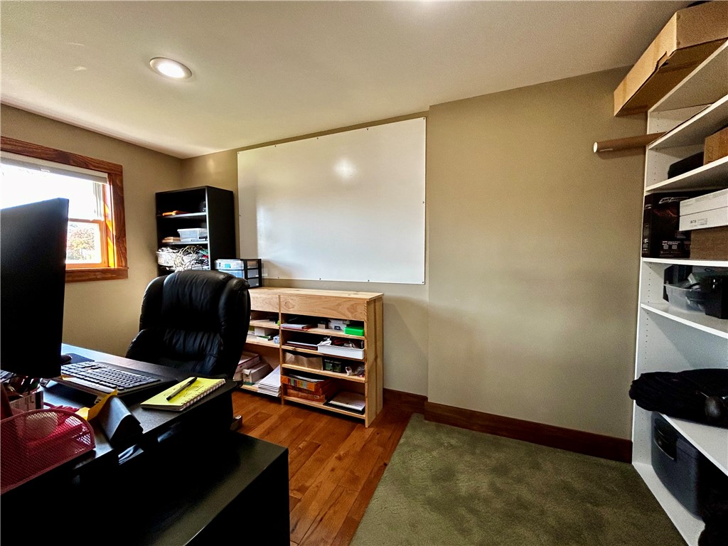 2086 Scheyhing Road Lewisburg, OH 45338 - Photo 17 of 29 An inviting home office featuring rich hardwood flooring and ample shelving for organized productivity.