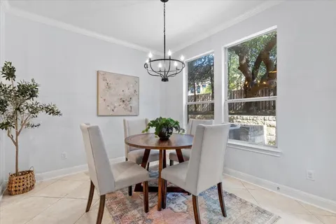 a dining room with furniture a window and a chandelier