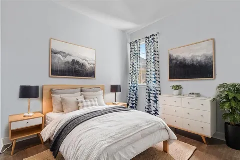 a bedroom with a bed and a flat screen tv